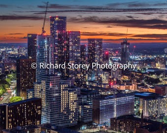 Fast evolving Manchester skyline with a beautiful orange sunset - Physical Print