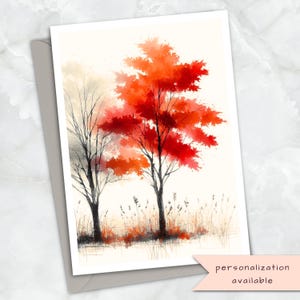 May include: Watercolor art print of two trees with vibrant red and orange leaves, set against a soft, neutral background. The artwork is on a white card with a gray envelope. Text on the bottom right corner reads "personalization available".