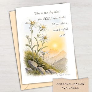 May include: A white ceramic mug with a black handle and the text "But First, Coffee" in a bold, black font. The mug is set against a blurred background, suggesting a cozy setting.