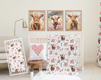 May include: A nursery room with a white crib, a white couch, and a white rug. The crib has a pink and white floral bedding set with a heart-shaped pillow. The walls are white and there are three framed pictures of Highland cows above the crib. The curtains are white with a pink floral pattern.