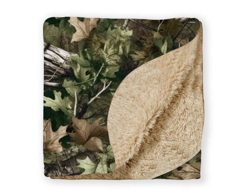 May include: A soft, plush blanket with a camouflage pattern on one side and a solid beige sherpa fleece on the other side.