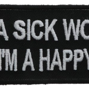 May include: A rectangular black embroidered patch with rounded corners featuring the white stitched text IT'S A SICK WORLD AND I'M A HAPPY GUY arranged in two lines. The lettering is in a bold, sans-serif font with a visible thread texture.