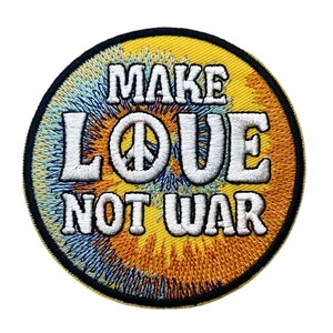 May include: A circular embroidered patch featuring a tie-dye background in shades of yellow, orange, and blue. The text "MAKE LOVE NOT WAR" is stitched in white with a black outline, with a peace symbol replacing the letter O in LOVE.