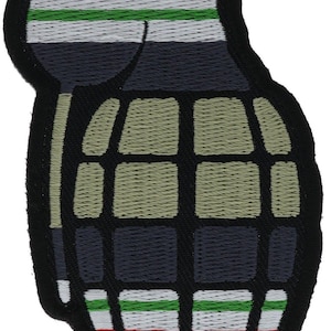 May include: An embroidered patch shaped like a hand grenade with a black border. The design features horizontal stripes of red, white, and green at the top and bottom, with a central grid pattern in muted olive green and dark gray tones.