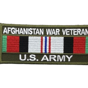 May include: A rectangular embroidered patch with an olive green border. The text AFGHANISTAN WAR VETERAN appears in white at the top, and U.S. ARMY appears in white at the bottom. A central ribbon graphic features vertical stripes of green, red, black, white, and blue.