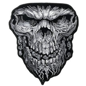 May include: A black and white embroidered patch featuring a detailed skull design. The skull has deep, dark eye sockets, prominent teeth, and intricate line work that creates a textured appearance. The edges of the patch are shaped to follow the skull's outline, with a solid black border surrounding the entire graphic.
