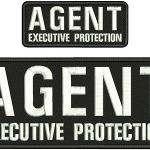 May include: Two rectangular black embroidered patches with white stitched borders. The larger patch and the smaller patch both feature the word AGENT in large capital letters above the text EXECUTIVE PROTECTION in smaller capital letters.