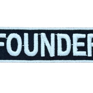 May include: A rectangular embroidered patch with a black background and a white border. The word FOUNDER is stitched in bold, white, capital letters across the center of the patch. The design features a clean, high-contrast aesthetic.
