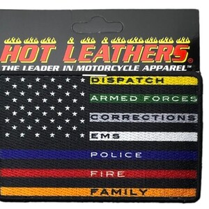 May include: A rectangular embroidered patch featuring a black American flag design with white stars. The stripes are colored lines with text: yellow DISPATCH, green ARMED FORCES, grey CORRECTIONS, white EMS, blue POLICE, red FIRE, and orange FAMILY.