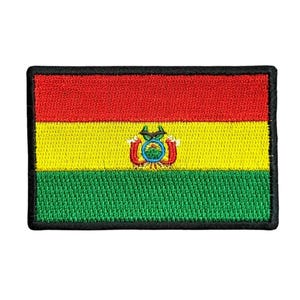 May include: A rectangular embroidered patch featuring the flag of Bolivia. The design consists of three horizontal stripes in red, yellow, and green, with the Bolivian coat of arms centered in the yellow stripe. The patch has a black border.