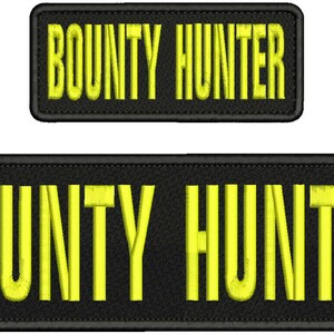 May include: Two rectangular embroidered patches with black fabric backgrounds and yellow stitched borders. Each patch features the text BOUNTY HUNTER in bold, yellow, capitalised, sans-serif lettering centred on the black surface.