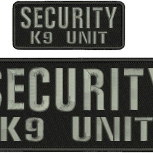 May include: Two rectangular embroidered patches with black fabric backgrounds and light gray stitching. The text SECURITY is embroidered in large capital letters on the top line, with K9 UNIT in smaller capital letters on the bottom line.
