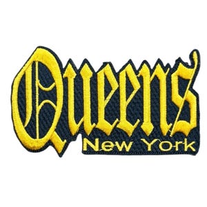 May include: An embroidered patch featuring the word Queens in a large, yellow, gothic-style font with a dark blue background. Below the word Queens, the text New York is embroidered in a smaller, yellow, sans-serif font on a dark blue base.