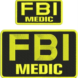 Puede incluir: Dos parches rectangulares bordados con esquinas redondeadas, fondo negro y borde amarillo brillante. El texto FBI está bordado en letras amarillas grandes sobre la palabra MEDIC en letras amarillas más pequeñas en ambos parches.