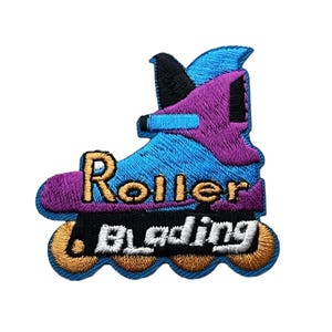 May include: An embroidered patch shaped like a rollerblade in shades of blue, purple, and black. The design features the text Roller in gold and Blading in white, with four gold wheels at the base. The patch has a blue stitched border.