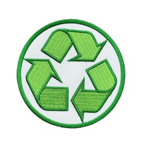 May include: A circular embroidered patch featuring the green recycling symbol on a white background. The design consists of three interlocking arrows arranged in a triangle, all outlined with a thick green border and detailed stitching.