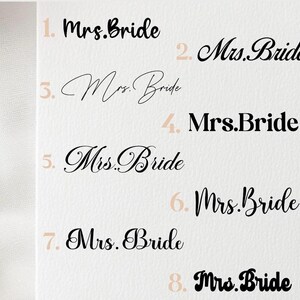May include: A collection of eight "Mrs. Bride" text designs in various fonts and styles. The text is in black and light brown, arranged on a light beige background. The designs are numbered from one to eight.