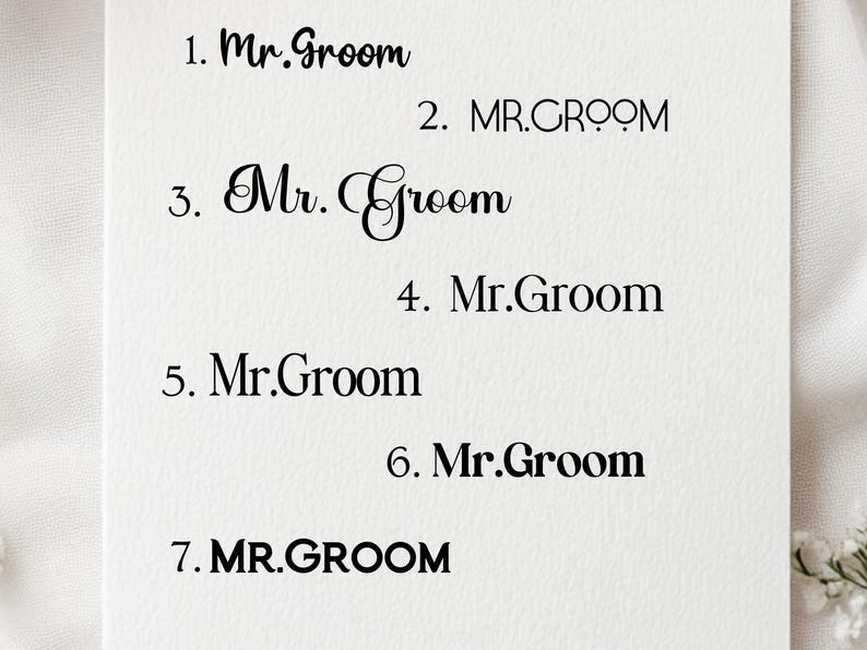 May include: A white card with seven different variations of the text "Mr. Groom" written in black ink. The text is written in different fonts and sizes.