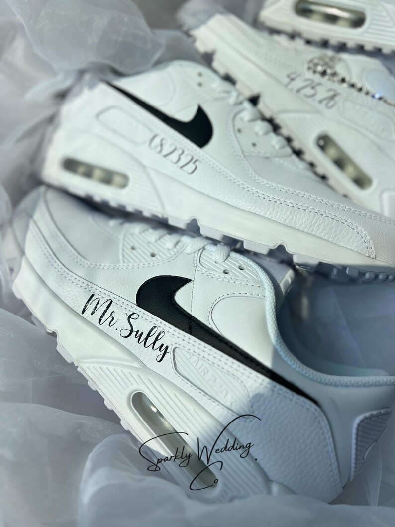 May include: White sneakers with black swoosh logos and personalized text. One pair reads "Mr. Sully" and another displays the date "6.8.2325". The shoes are part of a wedding theme, with the text "Sparkly Wedding Co."