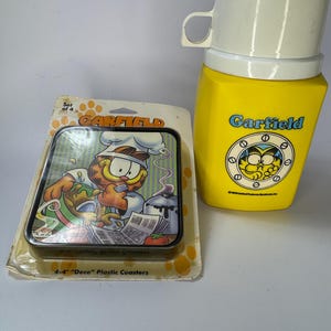 Vintage set of 1978 Garfield Yellow Thermos and 4 Garfield plastic coasters