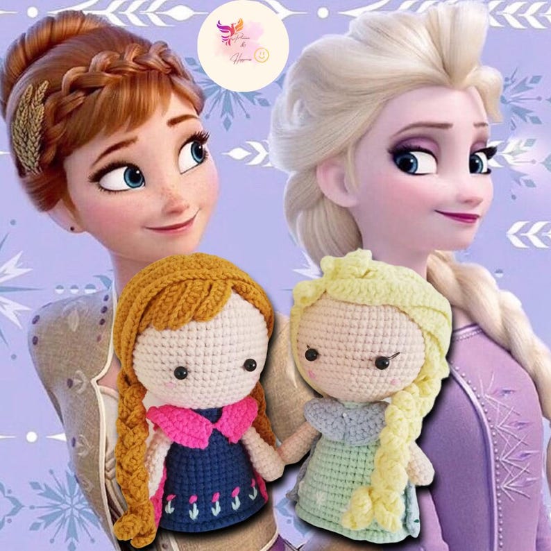 May include: Two crocheted dolls of the Disney characters Anna and Elsa from the movie Frozen. The dolls are wearing their signature dresses and have long braids. The dolls are sitting on a purple background with snowflakes.