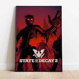 May include: A framed poster featuring a zombie illustration with a red and black color scheme. The image shows a zombie reaching out with its hand, with other zombies in the background. The text "STATE OF DECAY 2" is displayed.