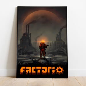 Puede incluir: Impresión enmarcada que presenta un paisaje industrial futurista con una figura con un traje rojo que sostiene un arma. La palabra "Factorio" se muestra en letras naranjas en la parte inferior.