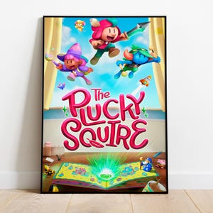 May include: A poster for the video game "The Plucky Squire". The poster features three cartoon characters, a pink and purple character with a wizard hat, a red and pink character with a crown, and a blue character with a green hat. The characters are jumping out of a book with a green glow. The book is open and has a yellow and brown cover.