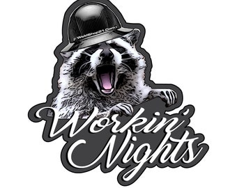 May include: A sticker featuring a raccoon wearing a black hard hat with the text "Workin' Nights" in a stylized font. The raccoon is depicted with its mouth open, as if yelling. The website "WeldShop21.com" is printed on the hat.