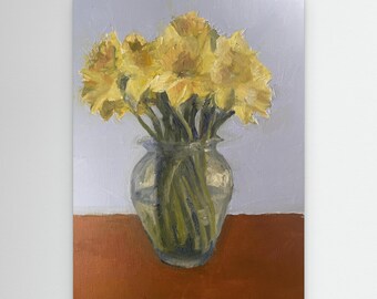 Daffodils in a green glass vase on a sunny day