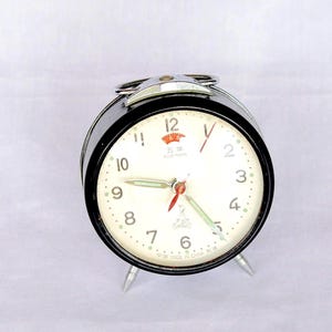 Vintage mid-century mechanical alarm clock, Black, Metal, Five Rams. Silver Metal with Handle,