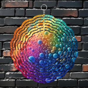 May include: A colourful metal wind spinner with a rainbow design and a swirling pattern of bubbles. The spinner is suspended from a silver hook.