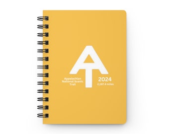 May include: A yellow spiral bound notebook with a white Appalachian Trail logo and the text "Appalachian National Scenic Trail 2024 2,197.4 miles".