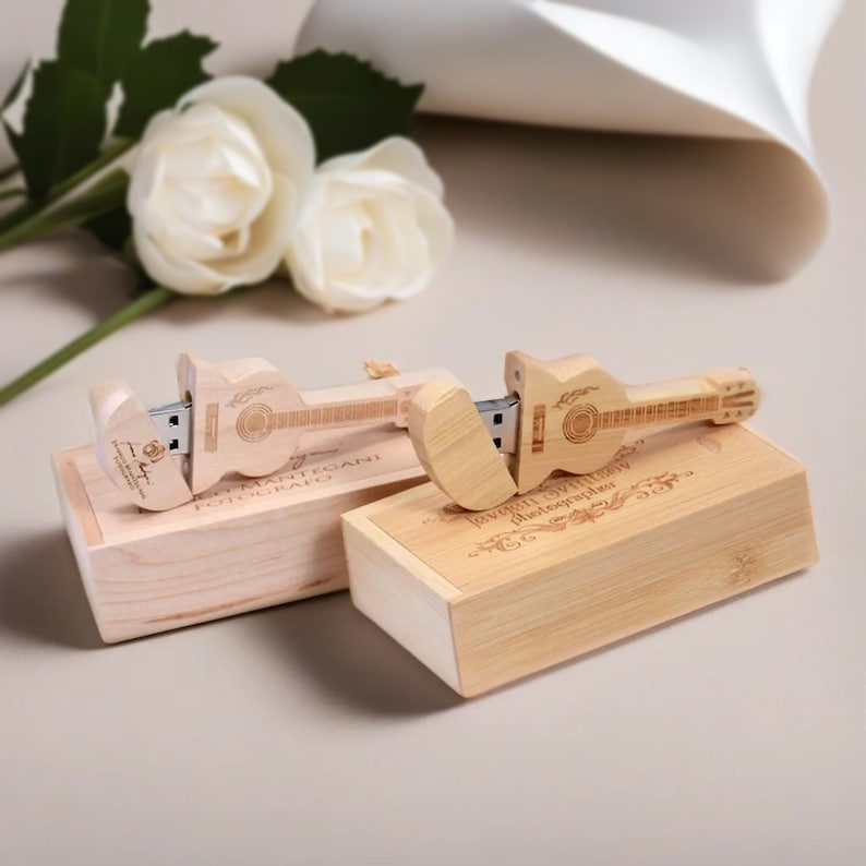 May include: Two wooden boxes with engraved text and a wooden guitar-shaped USB drive inside. The boxes are made of light wood and have a natural finish. The USB drive is a unique and personalized gift for a photographer.