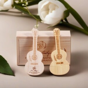 May include: Two wooden guitar-shaped USB drives in a wooden box. The drives are engraved with a guitar and the text "Franco Mantegani Fotografo".