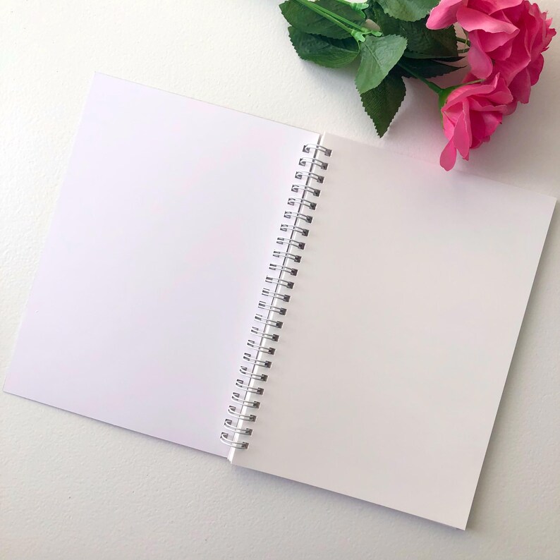 Image of the sticker book lying open to the inside blank waxy paper.