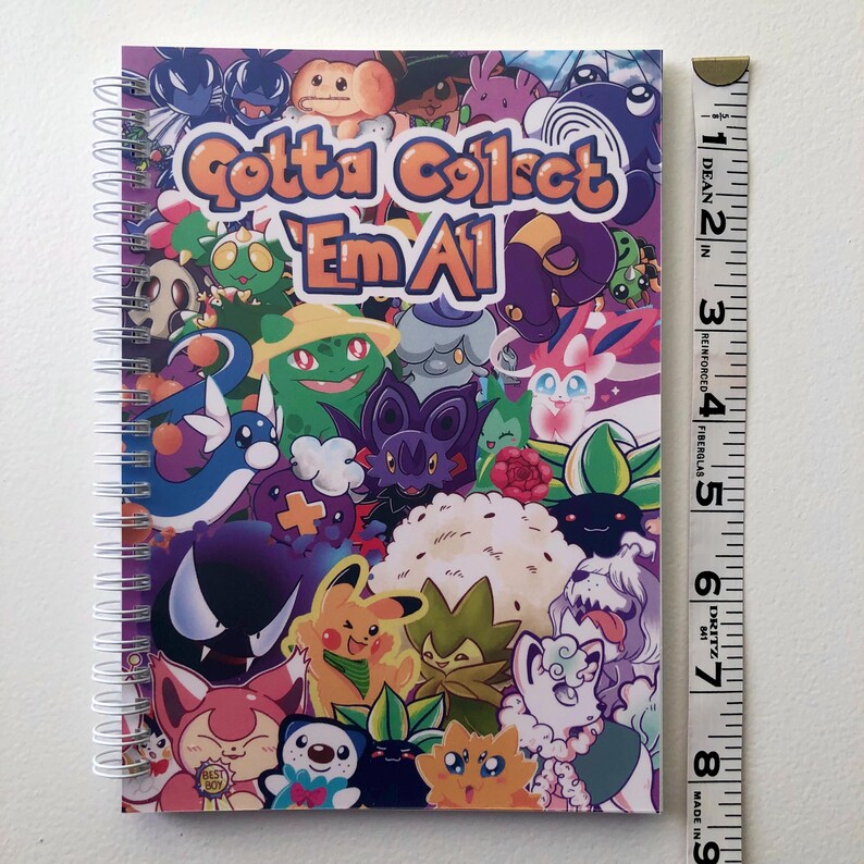 Image showing the length of the sticker book using a fabric ruler. It is 8.27 inches long