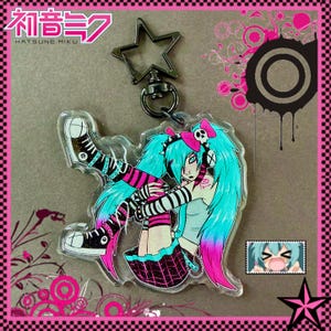 May include: A clear acrylic keychain featuring a stylized anime character with turquoise and pink hair, wearing a black and white striped outfit and high-top sneakers. The keychain has a star-shaped clasp and the text "Hatsune Miku".