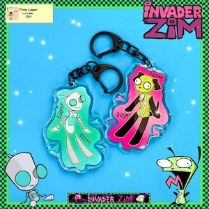 May include: Two Invader Zim character keychains. One is teal and white, the other is pink and black. Both have the word "DOOM!" printed on them. The keychains are attached to black metal clasps and chains. The background is blue.