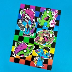 May include: A sheet of colorful stickers featuring cartoon characters with edgy, punk-inspired designs. The stickers include a green dinosaur with the word "RAWWR!" and other characters with vibrant hair and clothing, set against a checkered background.