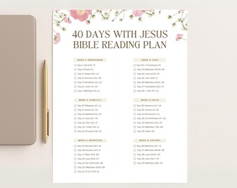 May include: A white Bible reading plan titled "40 Days With Jesus" with floral accents. The plan is divided into weeks with daily scripture references. A gold pen and a gray tablet are in the background.