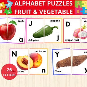 May include: Alphabet puzzle cards featuring fruits and vegetables. Each card has a letter, a picture of the fruit or vegetable, and the name of the fruit or vegetable. The letters are A, D, J, N, and Y. The fruits and vegetables are apple, dragon fruit, jalapeno, nectarine, and yam.