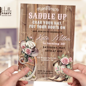 May include: A rustic wooden invitation with a pink and white cowboy hat, cowboy boots, and roses. The text reads "Saddle Up Grab Your Hat, Put Your Boots On And Join Us To Celebrate Kate Miller is turning 30! Saturday, May 18th at 4PM 123 Happy Party RD., Lockhart, TX RSVP To Ashley At 123-456-7890"