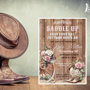 May include: A rustic wooden invitation with pink floral accents. The invitation reads "Saddle Up, Grab Your Hat, Put Your Boots On" and is for a 30th birthday party. The party is on Saturday, May 18th at 4pm. The invitation includes the address and RSVP information.