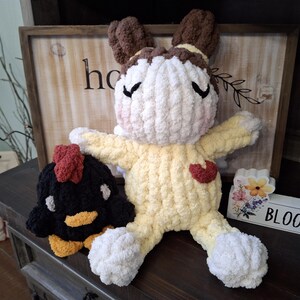 May include: A handmade, plush bunny doll with a yellow body, white limbs, and brown ears. A black and yellow chicken plush is next to the bunny. A wooden sign with the word "bloom" is also in the image.