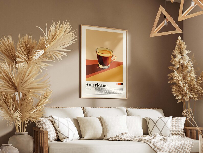 May include: A poster with a minimalist illustration of a cup of coffee with the word "Americano" printed below. The poster is framed in a light wood frame and hangs on a brown wall.