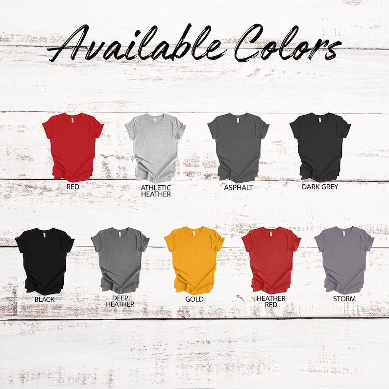 May include: Image showcasing a variety of t-shirt colors, including red, athletic heather, asphalt, dark grey, black, deep heather, gold, heather red, and storm. The text "Available Colors" is displayed at the top.