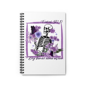 May include: White spiral-bound notebook with a purple framed illustration of a skeleton holding flowers and butterflies. The text "Ezekiel 37:1-10" and "Dry bones come alive" are included in the design.