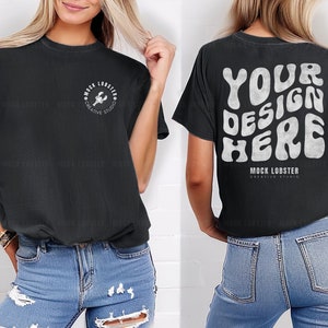 May include: Black t-shirt with a white graphic on the front that says "Mock Lobster Creative Studio" and a white graphic on the back that says "Your Design Here" with the text "Mock Lobster Creative Studio" underneath.