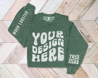 May include: A green sweatshirt with a white "Your Design Here" graphic printed on the front. The sweatshirt has a crew neck and long sleeves.